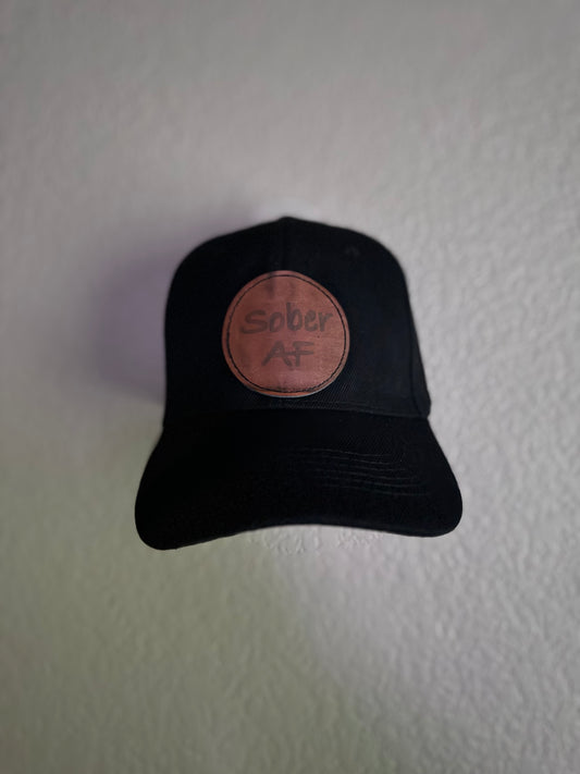 Black baseball cap with a brown leather patch